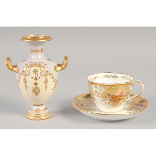 1109 - A 19TH CENTURY COALPORT GOLD GROUND CUP AND SAUCER painted with flowers and birds and a 19th century... 