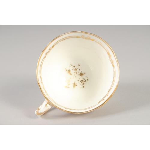 1109 - A 19TH CENTURY COALPORT GOLD GROUND CUP AND SAUCER painted with flowers and birds and a 19th century... 