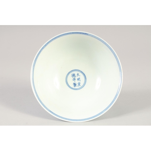 1137 - A CHINESE BLUE AND WHITE PORCELAIN STEM CUP with dragon and phoenix. 15.5cm diameter.