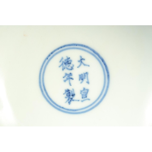 1137 - A CHINESE BLUE AND WHITE PORCELAIN STEM CUP with dragon and phoenix. 15.5cm diameter.