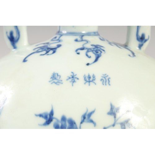 1140 - A CHINESE BLUE AND WHITE PORCELAIN MOON FLASK with twin handles and decorated with birds. 28cm high.... 