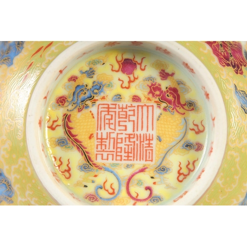 1144 - A CHINESE YELLOW GROUND FAMILLE ROSE BOWL decorated with cranes, six character mark to base. 15cm di... 