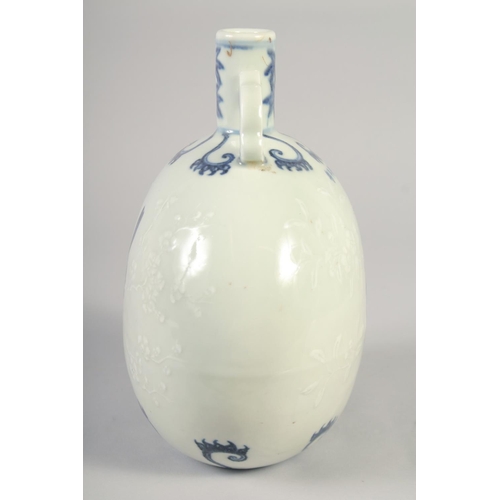 1145 - A CHINESE BLUE AND WHITE PORCELAIN MOON FLASK with twin handles, birds and carved decoration. 25.5in... 