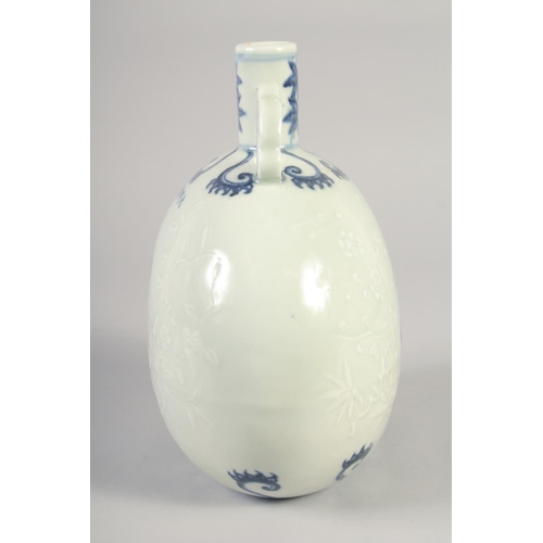 1145 - A CHINESE BLUE AND WHITE PORCELAIN MOON FLASK with twin handles, birds and carved decoration. 25.5in... 