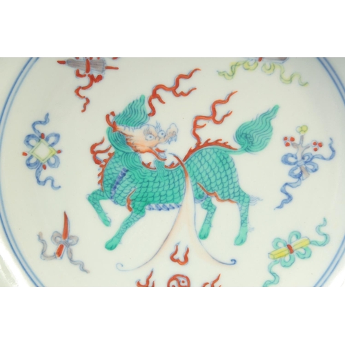 1151 - A CHINESE DOUCAI PORCELAIN DISH with Kylin and lucky objects. 21.5cm diameter.