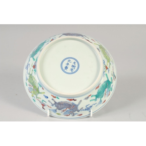 1151 - A CHINESE DOUCAI PORCELAIN DISH with Kylin and lucky objects. 21.5cm diameter.