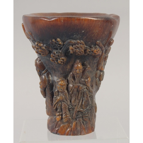 1157 - A GOOD CHINESE CARVED HORN LIBATION CUP carved with lotus and figures. 5.5ins.