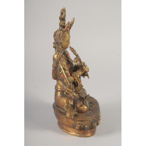 1161 - A GILT BRONZE BUDDHA with eight arms, set with stones.