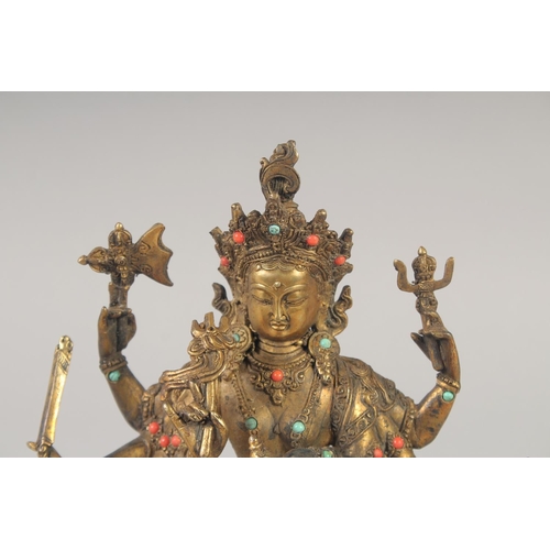 1161 - A GILT BRONZE BUDDHA with eight arms, set with stones.