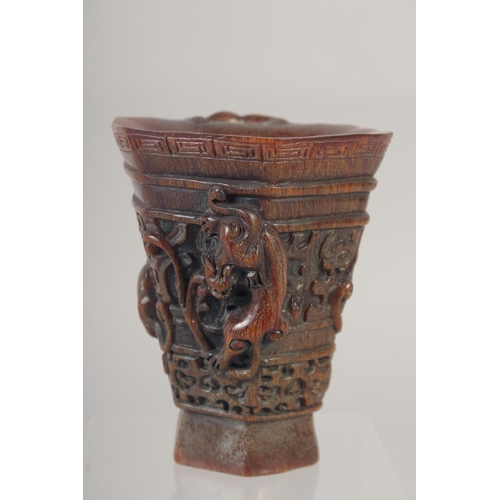 1166 - A GOOD CHINESE CARVED WOOD LIBATION CUP with handle. 5ins high.