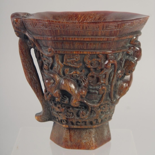 1166 - A GOOD CHINESE CARVED WOOD LIBATION CUP with handle. 5ins high.