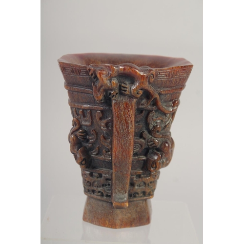 1166 - A GOOD CHINESE CARVED WOOD LIBATION CUP with handle. 5ins high.