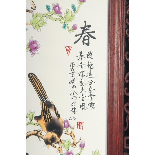 1169 - A PAIR OF UPRIGHT CHINESE PORCELAIN PANELS, birds and flowers in wooden frames.