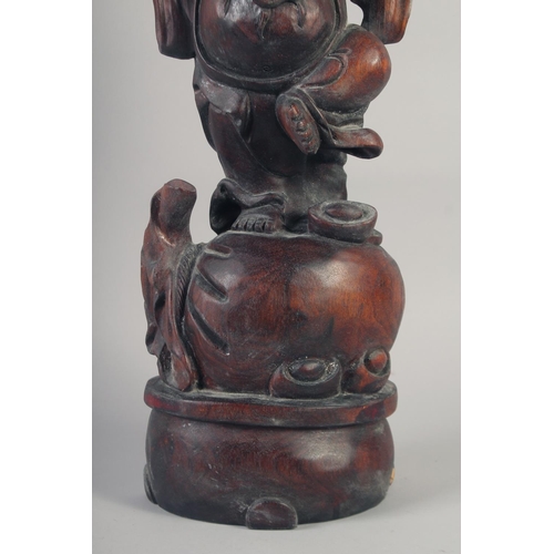 1173 - A CARVED ROSEWOOD BUDDHA. 26ins long.