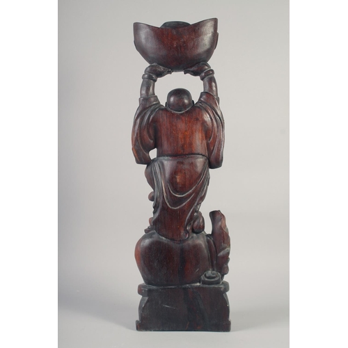 1173 - A CARVED ROSEWOOD BUDDHA. 26ins long.