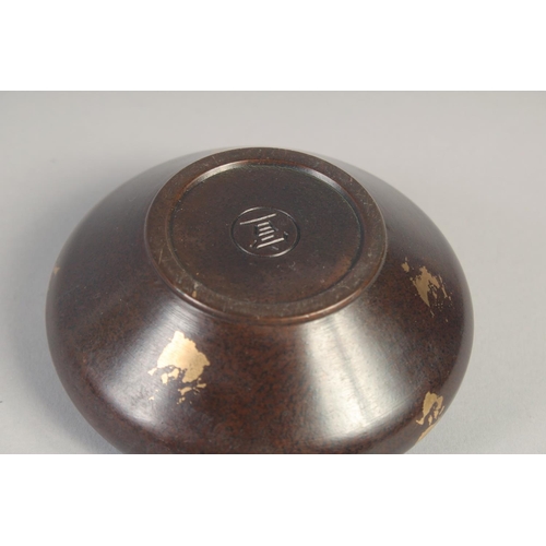 1174 - A CHINESE CIRCULAR BRONZE GOLD SPLASH CENSER AND COVER. 3.75ins diameter.