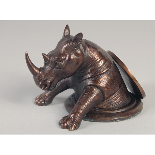 1175 - A CHINESE CIRCULAR BRONZE RHINO. 4ins.