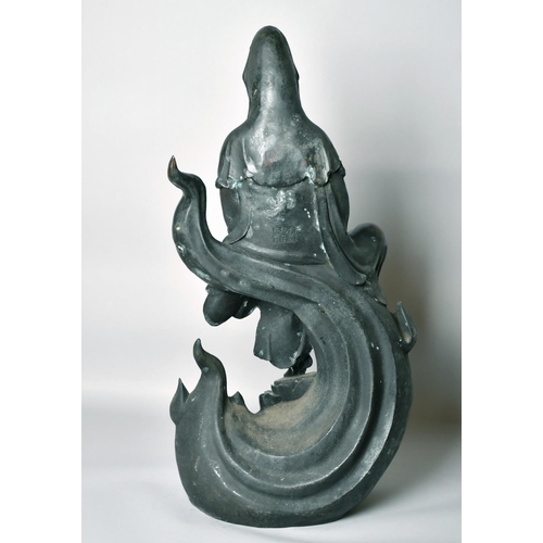 1221 - A LARGE CHINESE BRONZE FIGURE OF GUANVIN sitting atop a wave, holding a sceptre, bearing a six-chara... 