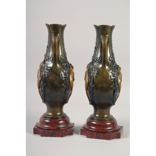 1234 - A VERY GOOD PAIR OF BRONZE AND GILDED BRONZE TWO HANDLED VASES with oval panels of a nude and flower... 