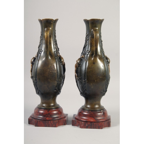 1234 - A VERY GOOD PAIR OF BRONZE AND GILDED BRONZE TWO HANDLED VASES with oval panels of a nude and flower... 