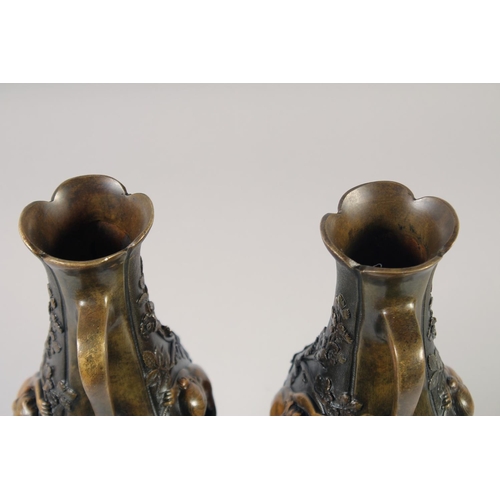 1234 - A VERY GOOD PAIR OF BRONZE AND GILDED BRONZE TWO HANDLED VASES with oval panels of a nude and flower... 