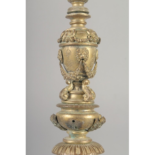 1242 - A GOOD SET OF FOUR 18TH CENTURY VENETIAN GILT BRONZE ALTER STYLE CANDLESTICKS with a cylindrical sco... 