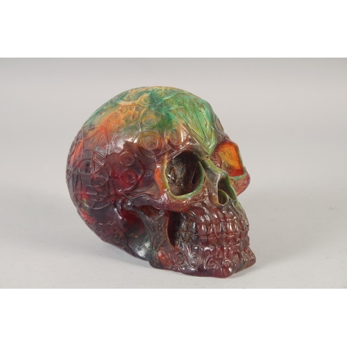 1247 - A CARVED AMBER STYLE SKULL.