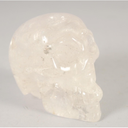 1249 - A SMALL CARVED ROCK CRYSTAL SKULL.