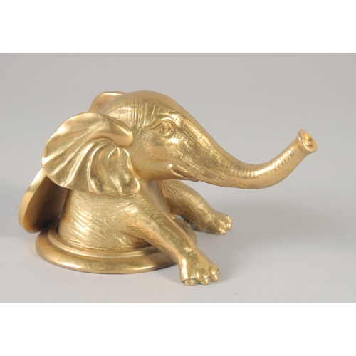 1278 - A GILT BRONZE ELEPHANT on a circular base. 6ins