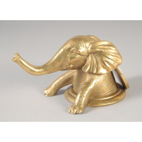 1278 - A GILT BRONZE ELEPHANT on a circular base. 6ins