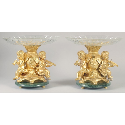 1279 - A VERY GOOD PAIR OF GILT BRONZE COMPORTS with gilt bowls and cupid supports.