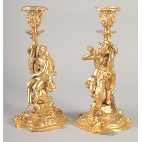 1281 - A GOOD PAIR OF GILT BRONZE CANDLESTICKS, the stems with classical figures, semi nude and man riding ... 