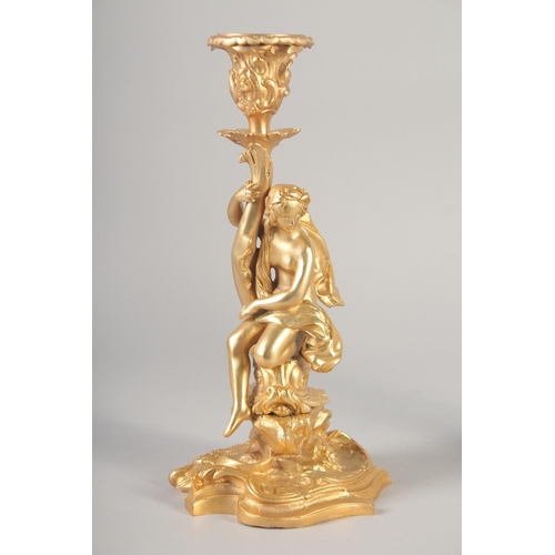 1281 - A GOOD PAIR OF GILT BRONZE CANDLESTICKS, the stems with classical figures, semi nude and man riding ... 