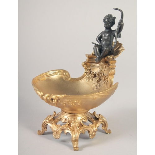 1283 - A GILT BRONZE AND BRONZE SALT with a cherub. 6.5ins.