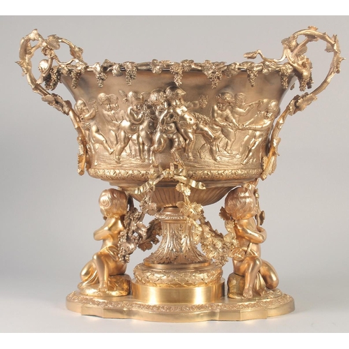 1284 - A SUPERB GILT BRONZE CHERUB CENTRE PIECE hung with fruiting vines and cupids. 16ins high x 16ins lon... 