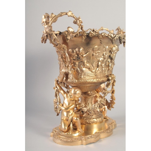 1284 - A SUPERB GILT BRONZE CHERUB CENTRE PIECE hung with fruiting vines and cupids. 16ins high x 16ins lon... 