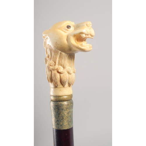 1291 - A WALKING STICK with carved bone handle 