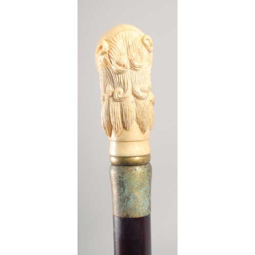 1291 - A WALKING STICK with carved bone handle 