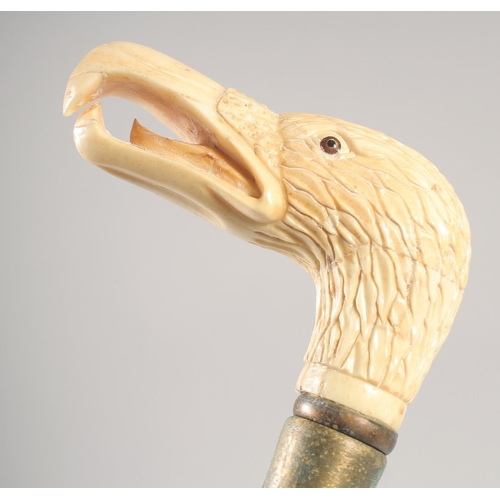 1293 - A WALKING STICK with carved bone handle 