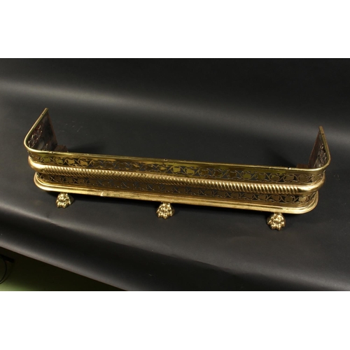 1315 - A 19TH CENTURY BRASS FENDER with pierced fretwork front on brass claw feet. 3ft 7ins long, 10ins dee... 