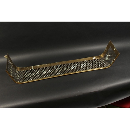 1316 - A 19TH CENTURY BRASS FENDER with pierced fretwork front on brass claw feet. 4ft long 11ins deep.