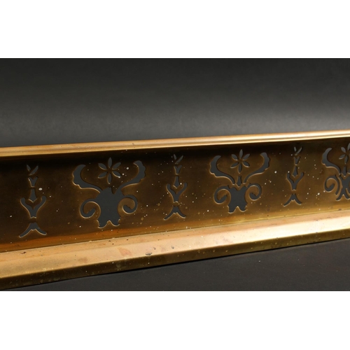 1317 - A 19TH CENTURY BRASS FENDER with pierced fretwork front and urn finials 4ft 2ins long, 1ft 1ins deep... 