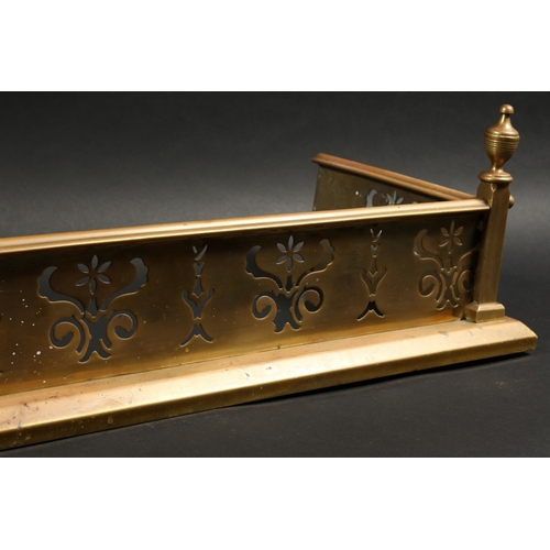 1317 - A 19TH CENTURY BRASS FENDER with pierced fretwork front and urn finials 4ft 2ins long, 1ft 1ins deep... 