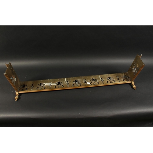 1317 - A 19TH CENTURY BRASS FENDER with pierced fretwork front and urn finials 4ft 2ins long, 1ft 1ins deep... 