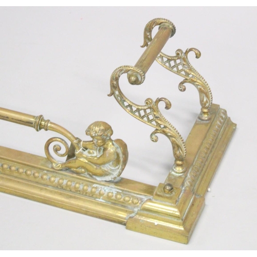 1319 - A GOOD 19TH CENTURY BRASS FENDER with cupid supports and pierced sides. 5ft long, 1ft 1ins deep.