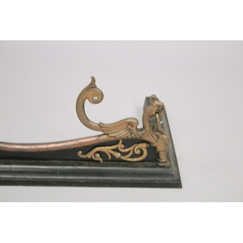 1325 - A VICTORIAN STEEL AND CAST IRON SERPENTINE SHAPED FENDER with lion ring handles. 4ft 4ins long, 1ft ... 