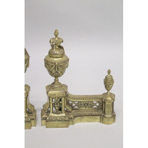 1328 - A GOOD PAIR OF 19TH CENTURY CAST BRASS CHENETS with urn finials. 1ft 3ins high, 11ins wide.