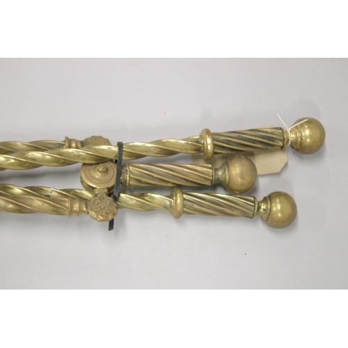 1331 - A SET OF THREE VICTORIAN BRASS FIRE IRONS.