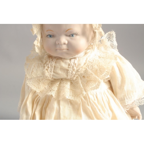 1363 - A PORCELAIN HEADED BABY DOLL. 14ins long.