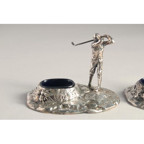 1369 - A PAIR OF SILVER PLATED GOLFER SALTS with blue liners.